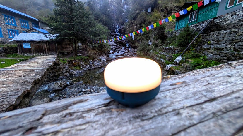 lantern - the black diamond moji r+ perched on a log as the sun sets in the...