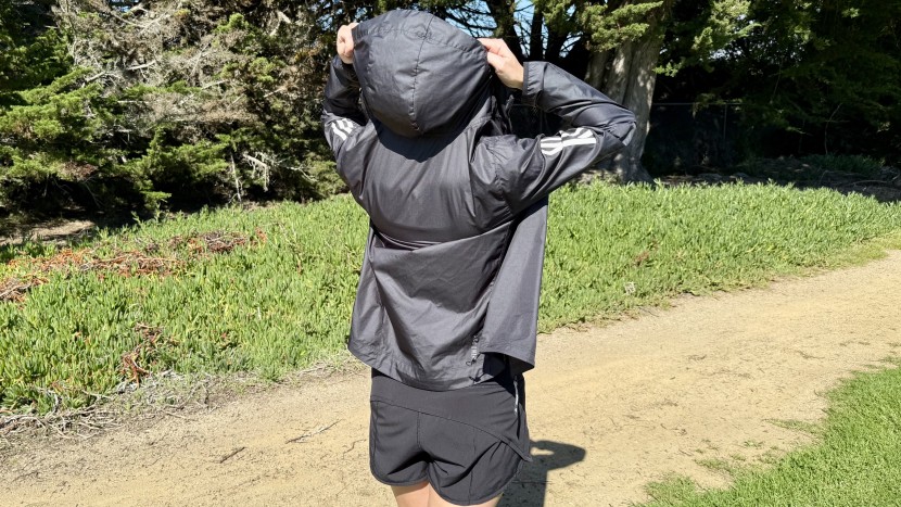 the adidas own the run jacket features a large and accommodating hood.