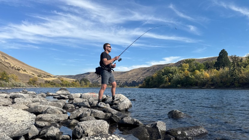 author chris maxcer casts the ugly stik gx2 while fishing on a river...