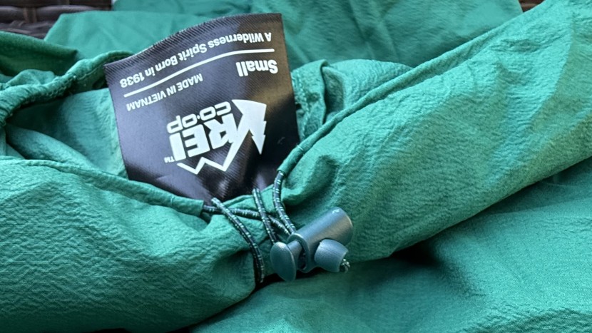 rei co-op swiftland windshell for women - the hood curls up and can be secured by a small bungee, allowing it...