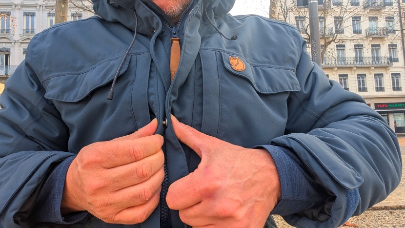 flaps from either side criss-cross over the zipper and snap shut...