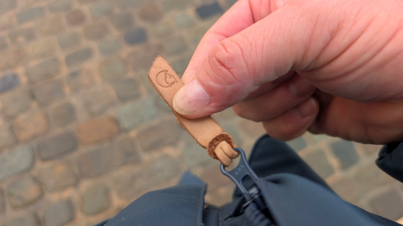 leather zipper pulls are the cherry on top of this classically...