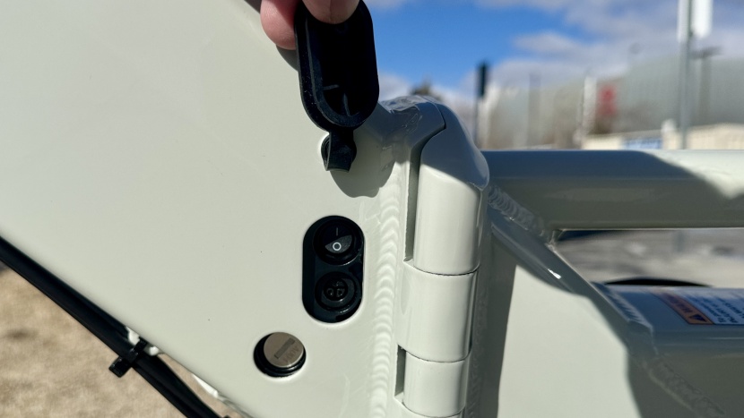 the charge port and power button are located beneath this rubber...